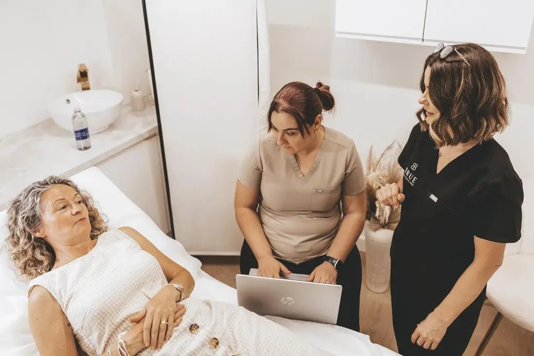 A student working at a laptop in the clinic treatment room