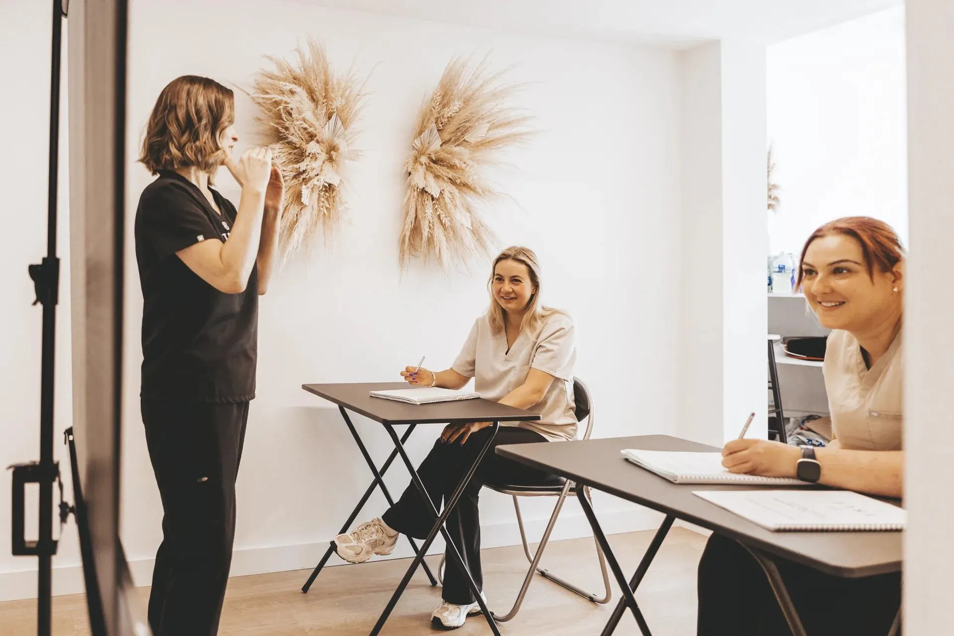 Students taking notes during a practical demonstration in the training room