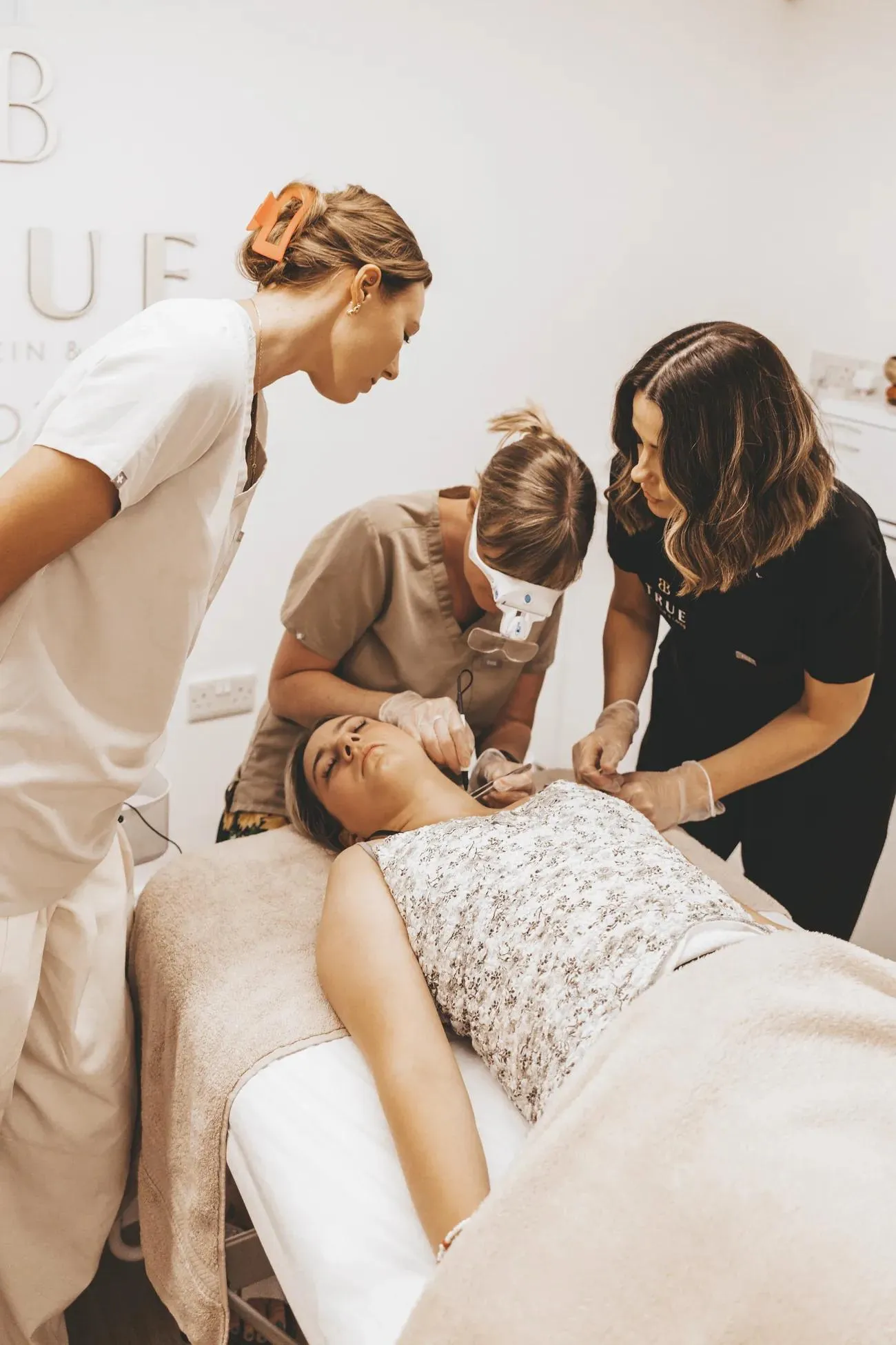 Sarah watching closely as a student performs an advanced electrolysis treatment