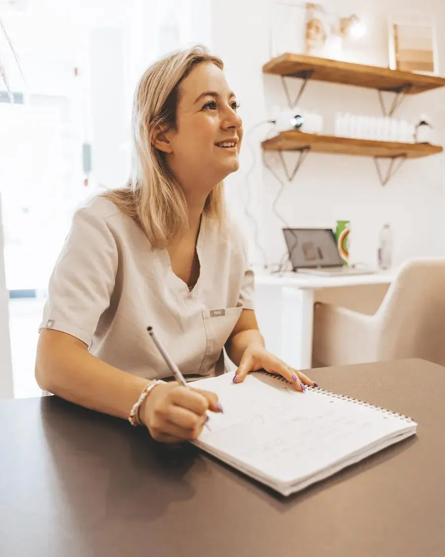 A student writing up her workbook during a training day